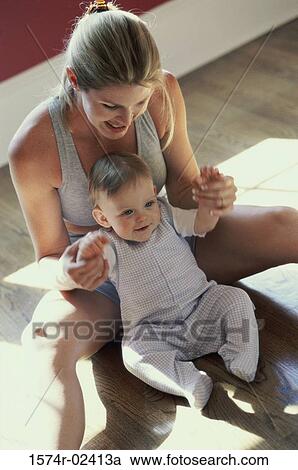 High angle view of a mother playing with her baby boy View Large Photo Image Stock Image - High angle view of a mother playing with her baby boy. Fotosearch