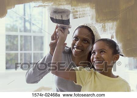 Stock Image - Mother and her daughter painting. Fotosearch