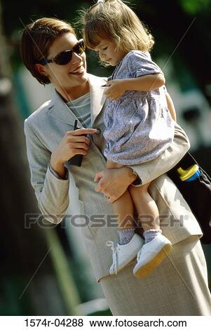 Mother carrying her daughter View Large Photo Image Stock Photo - Mother carrying her daughter. Fotosearch