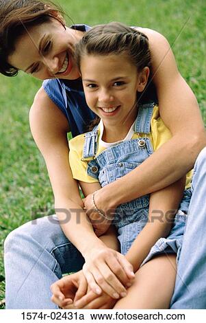 Mother hugging her daughter View Large Photo Image Stock Image - Mother hugging her daughter. Fotosearch
