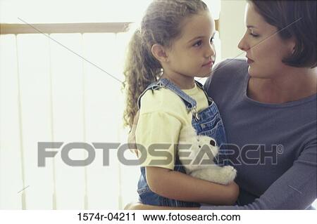 Mother hugging her daughter View Large Photo Image Stock Image - Mother hugging her daughter. Fotosearch