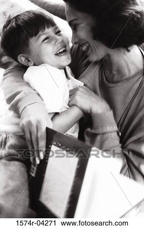 Stock Image - Mother hugging her son. Fotosearch