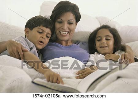 Mother lying in bed with her son and daughter View Large Photo Image Stock Image - Mother lying in bed with her son and daughter. Fotosearch