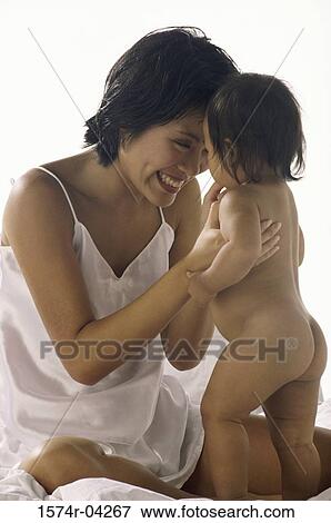 Stock Photo - Mother playing with her baby boy. Fotosearch