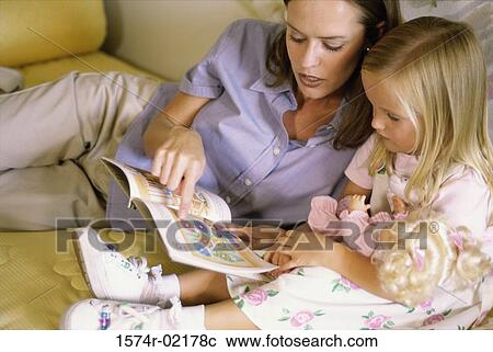 Mother reading a book with her daughter View Large Photo Image Stock Image - Mother reading a book with her daughter. Fotosearch