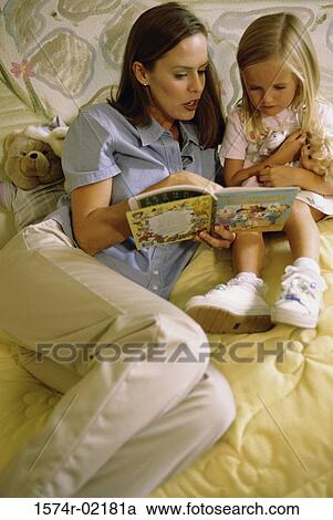 Mother reading a book with her daughter View Large Photo Image Stock Image - Mother reading a book with her daughter. Fotosearch