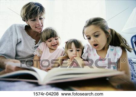 Stock Photo - Mother reading a book with her three daughters. Fotosearch