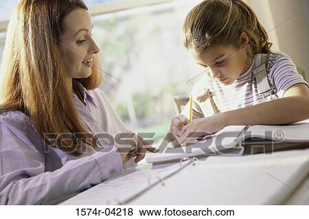Mother teaching her daughter View Large Photo Image Stock Photo - Mother teaching her daughter. Fotosearch