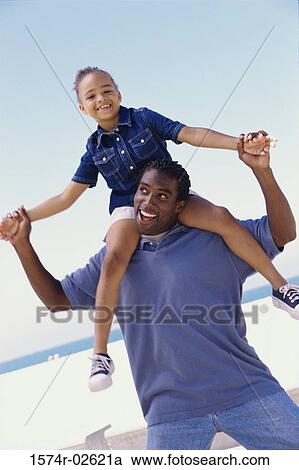 Portrait of a father carrying his daughter on his shoulders View Large Photo Image Stock Image - Portrait of a father carrying his daughter on his shoulders. Fotosearch