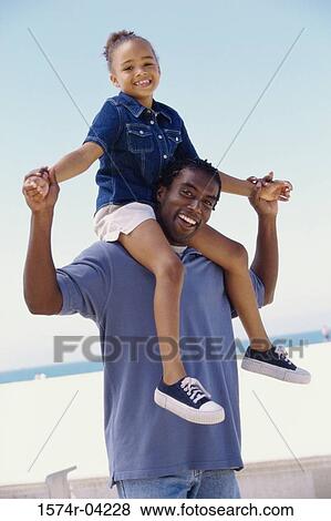 Portrait of a father carrying his daughter on his shoulders View Large Photo Image Stock Photo - Portrait of a father carrying his daughter on his shoulders. Fotosearch
