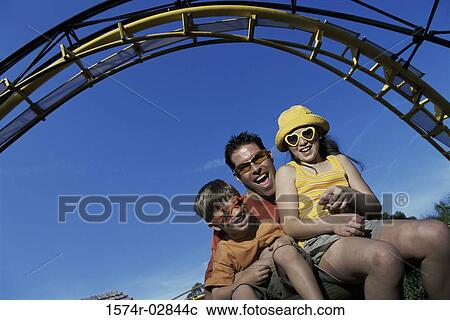 Portrait of a father with his son and daughter on an amusement park ride View Large Photo Image Stock Image - Portrait of a father with his son and daughter on an amusement park ride. Fotosearch