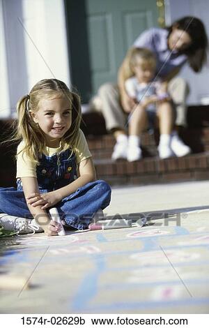 Portrait of a girl drawing on the floor with chalk View Large Photo Image Stock Image - Portrait of a girl drawing on the floor with chalk. Fotosearch