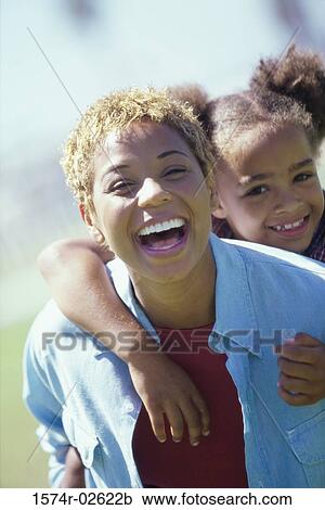 Portrait of a girl riding piggyback on her mother View Large Photo Image Stock Image - Portrait of a girl riding piggyback on her mother. Fotosearch