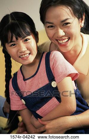 Portrait of a mother and her daughter smiling View Large Photo Image Stock Image - Portrait of a mother and her daughter smiling. Fotosearch