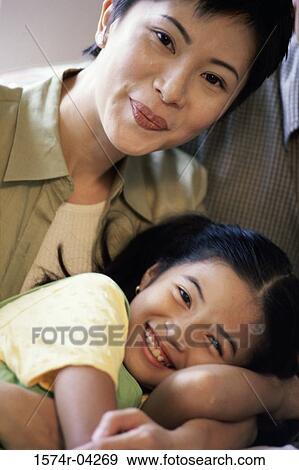 Portrait of a mother and her daughter smiling View Large Photo Image Stock Photo - Portrait of a mother and her daughter smiling. Fotosearch