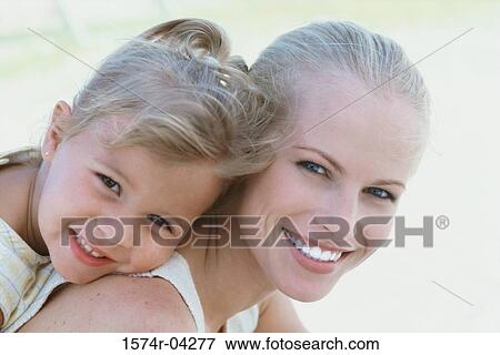 Stock Photo - Portrait of a mother and her daughter smiling. Fotosearch