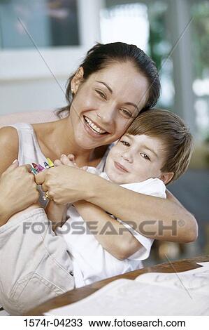 Stock Image - Portrait of a mother hugging her son. Fotosearch