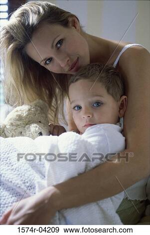Stock Photo - Portrait of a mother hugging her son. Fotosearch