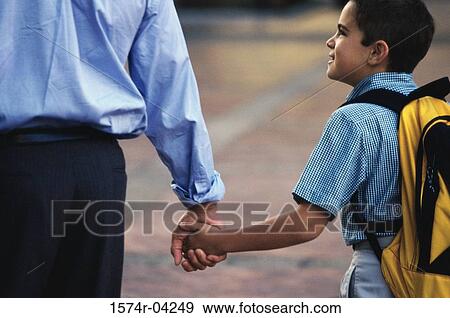 Stock Photo - Rear view of a father and his son holding hands. Fotosearch
