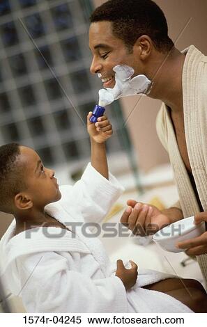 Side profile of a boy applying shaving cream on his father's face View Large Photo Image Stock Photography - Side profile of a boy applying shaving cream on his father's face. Fotosearch