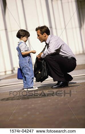 Stock Photo - Side profile of a father talking to his son. Fotosearch