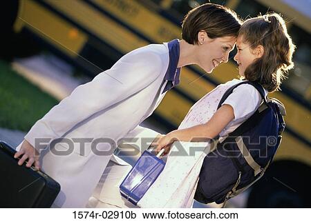 Side profile of a mother and her daughter looking at each other View Large Photo Image Stock Image - Side profile of a mother and her daughter looking at each other. Fotosearch