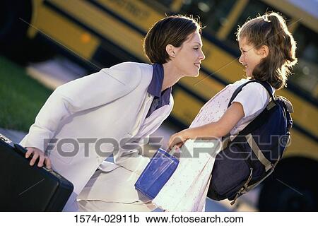Side profile of a mother dropping her daughter off at school View Large Photo Image Stock Image - Side profile of a mother dropping her daughter off at school. Fotosearch
