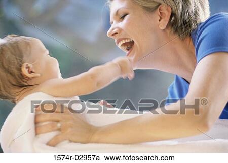 Side profile of a mother holding her baby boy View Large Photo Image Stock Image - Side profile of a mother holding her baby boy. Fotosearch