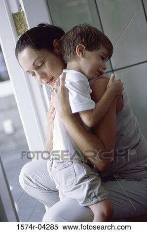 Stock Photography - Side profile of a mother hugging her son. Fotosearch