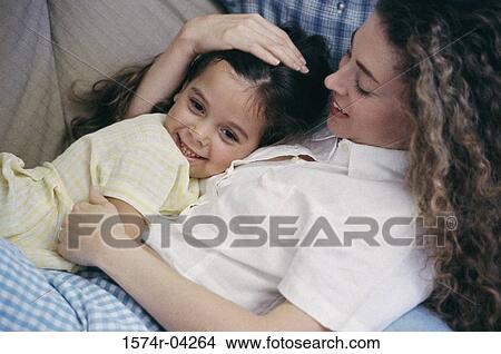 Side profile of a mother sleeping with her daughter View Large Photo Image Picture - Side profile of a mother sleeping with her daughter. Fotosearch