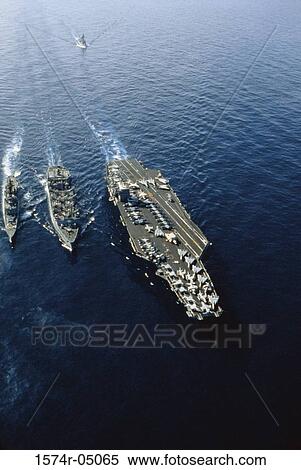 Stock Photography - Aerial view of the USS Nimitz aircraft carrier with three warships in the sea. Fotosearch