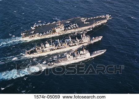 Aerial view of three military ships sailing in the sea View Large Photo Image Stock Photo - Aerial view of three military ships sailing in the sea. Fotosearch