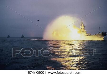 Stock Image - Battleship USS Iowa firing guns. Fotosearch