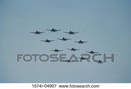 Stock Photo - Low angle view of A-10 Thunderbolt fighter planes flying in formation. Fotosearch