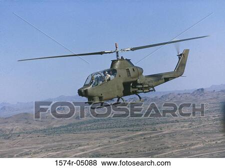 Stock Photo - Low angle view of a Cobra Attack helicopter in flight. Fotosearch