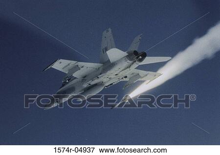 Stock Photo - Low angle view of a fighter plane firing a missile. Fotosearch