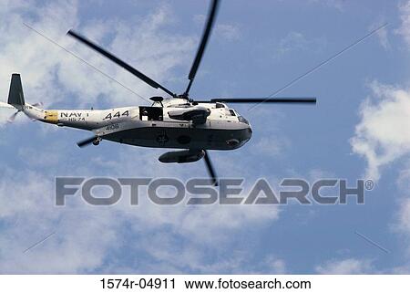 Stock Image - Low angle view of a military helicopter in flight. Fotosearch
