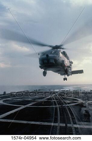 Low angle view of a SH-60B Sea Hawk helicopter landing on the deck of the USS Nicholas aircraft carrier View Large Photo Image Picture - Low angle view of a SH-60B Sea Hawk helicopter landing on the deck of the USS Nicholas aircraft carrier. Fotosearch