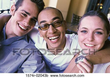 Close-up of a two men and a woman hugging View Large Photo Image Stock Image - Close-up of a two men and a woman hugging. Fotosearch