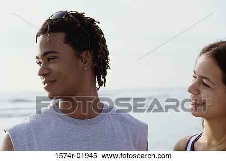 Stock Photography - Close-up of a young couple at the beach. Fotosearch