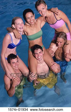 Group of teenage girls sitting on teenage boys shoulders in the water View Large Photo Image Picture - Group of teenage girls sitting on teenage boys shoulders in the water. Fotosearch