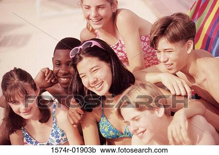 Stock Image - Group of teenagers at the beach. Fotosearch