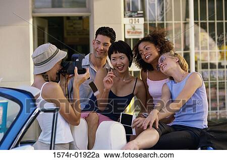 Group of teenagers posing in a convertible car View Large Photo Image Stock Image - Group of teenagers posing in a convertible car. Fotosearch