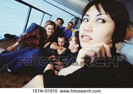 Group of young men and women sitting indoors View Large Photo Image Stock Image - Group of young men and women sitting indoors. Fotosearch