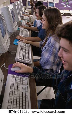 High angle view of teenage students working in a computer room View Large Photo Image Stock Image - High angle view of teenage students working in a computer room. Fotosearch