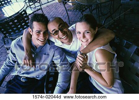 High angle view of two men and a woman in a cafe View Large Photo Image Stock Image - High angle view of two men and a woman in a cafe. Fotosearch