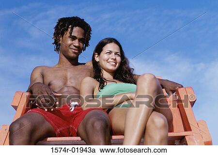 Stock Image - Low angle view of a young couple. Fotosearch