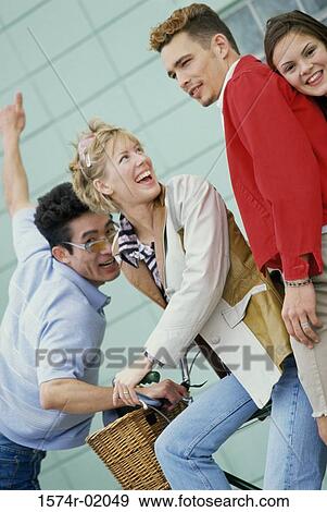 Low angle view of two young couples standing outdoors View Large Photo Image Stock Photo - Low angle view of two young couples standing outdoors. Fotosearch