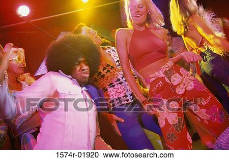 Low angle view of young men and women dancing in a discotheque View Large Photo Image Stock Image - Low angle view of young men and women dancing in a discotheque. Fotosearch