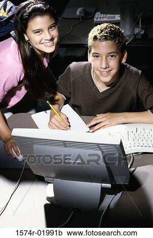 Portrait of a teenage boy and a teenage girl in front of a computer monitor View Large Photo Image Stock Image - Portrait of a teenage boy and a teenage girl in front of a computer monitor. Fotosearch